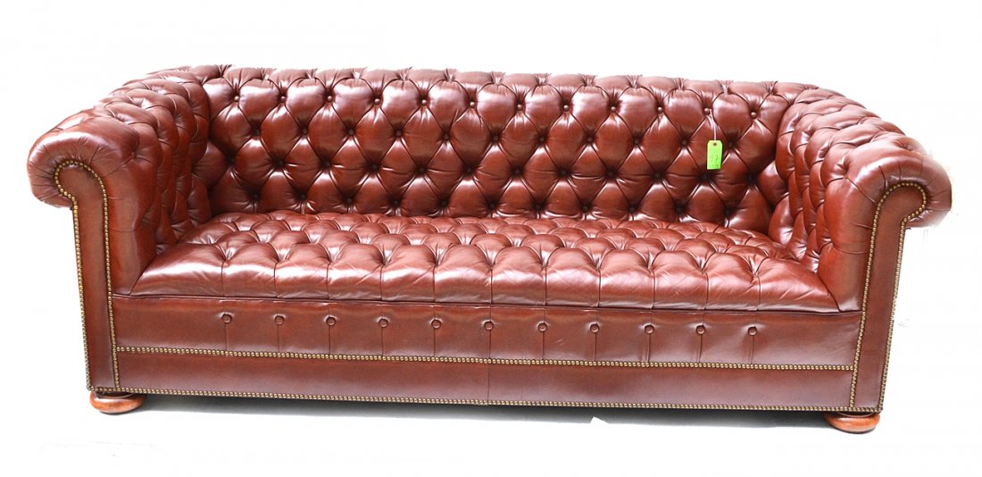 Chesterfield Sofa: Chestnut colored leather button tufted sofa with bun feet. [88" W x 35" D x 32" H]. In very good condition.
