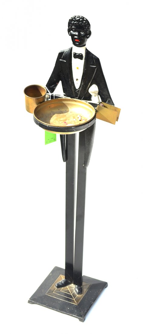 Cast Iron Smoking Stand: Circa 1930s. In the form of a standing butler, having an ash receiver, cigarette and match holder.