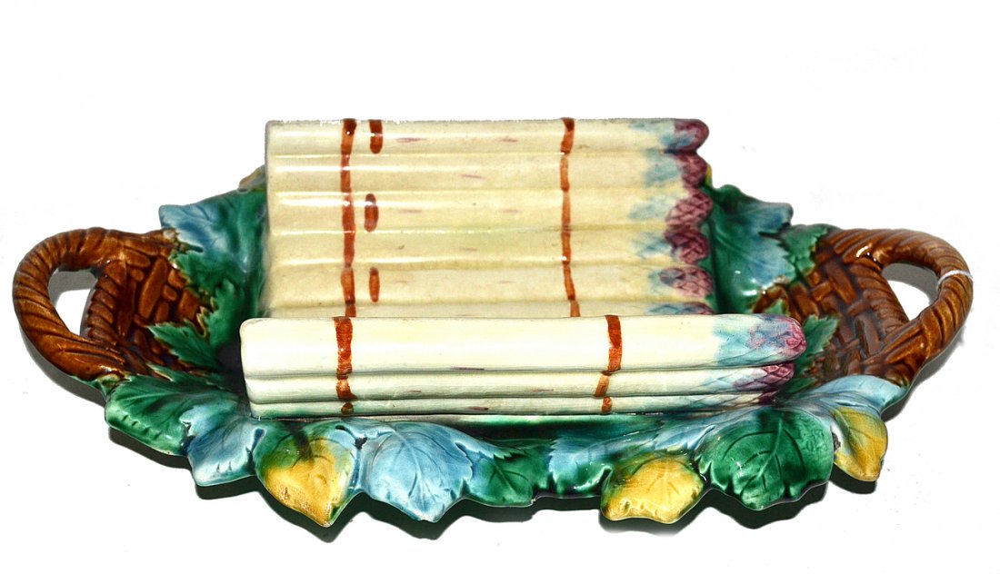 Antique Majolica Asparagus Dish: Modeled in the form of an arched group of asparagus in basket lined with grape liners. [15 3/8" L].
