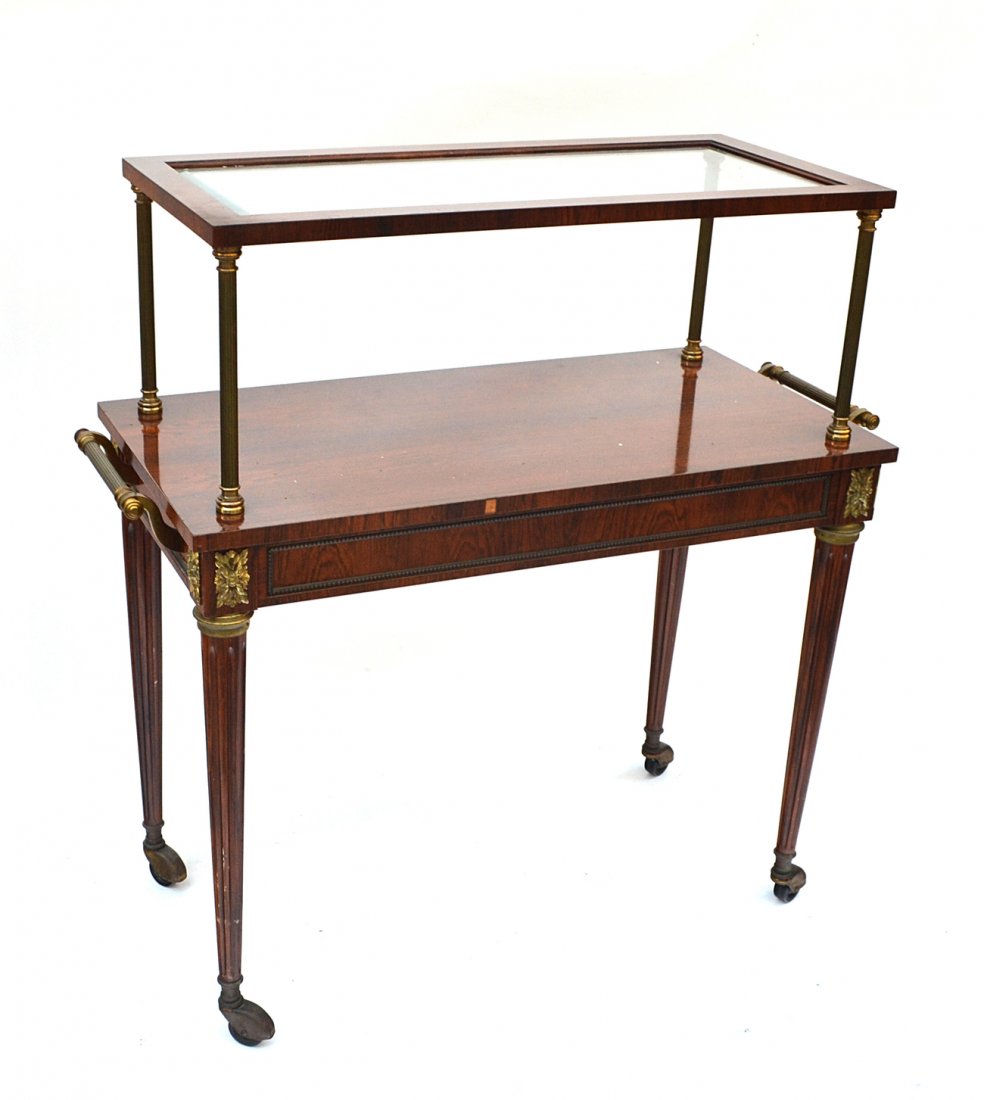 Sheraton Style Two Tier Stand: Rosewood and brass rolling stand with inset glass shelf. [41" H x 40" W x 18"].