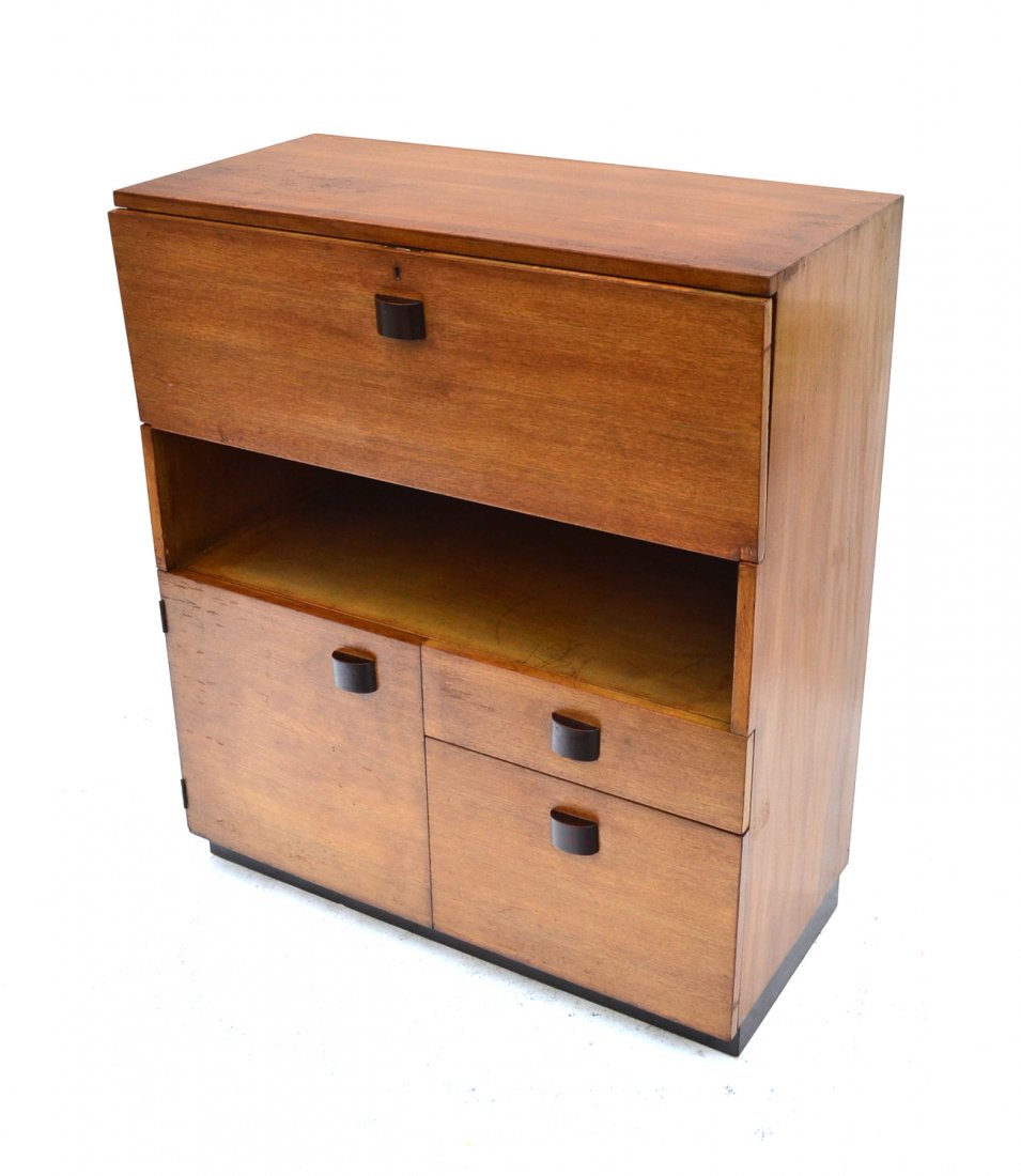 Gilbert Rohde for Herman Miller Chest: Early unit chest by Rohde, having an full front compartments over an open shelf, with two lower drawers and one door. Circa 1933. En suite with above.