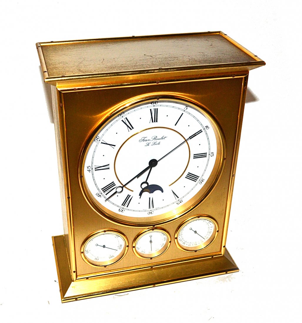 Jean Roulet "LeLocle" Clock: Gilt bronze clock with electric Swiss made movement. Features face plate with Roman numerals and moon phase dial above day of week, month and date dials. [7 3/4" x 4" x 10 1/4"]. Light wear. Provenanc
