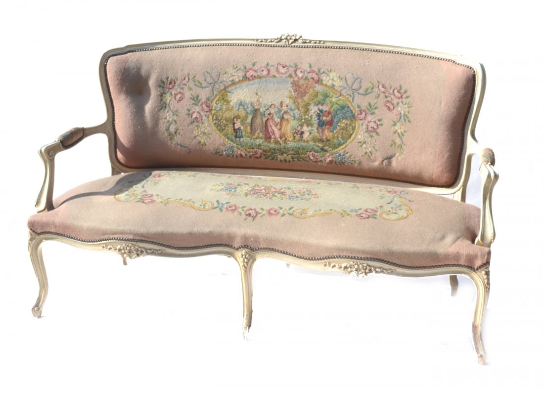 Louis XV Style Settee: Louis XV style painted and carved settee with elaborate scenic needlepoint upholstery. [66" W x 21 1/2" D x 38 1/2" H]. Good condition.
