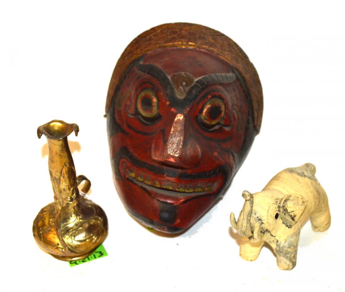 International Vintage Decorative Articles: Comprises 1) Indonesian carved wood mask (nose broken with loss) [6 1/4" W x 5 3/4" D x 7 3/4" H] 2) Composition elephant with raised trunk (one ear missing) [5 1/4" W x 2 1/8" D x 4 1/4" H] 3) Gold f