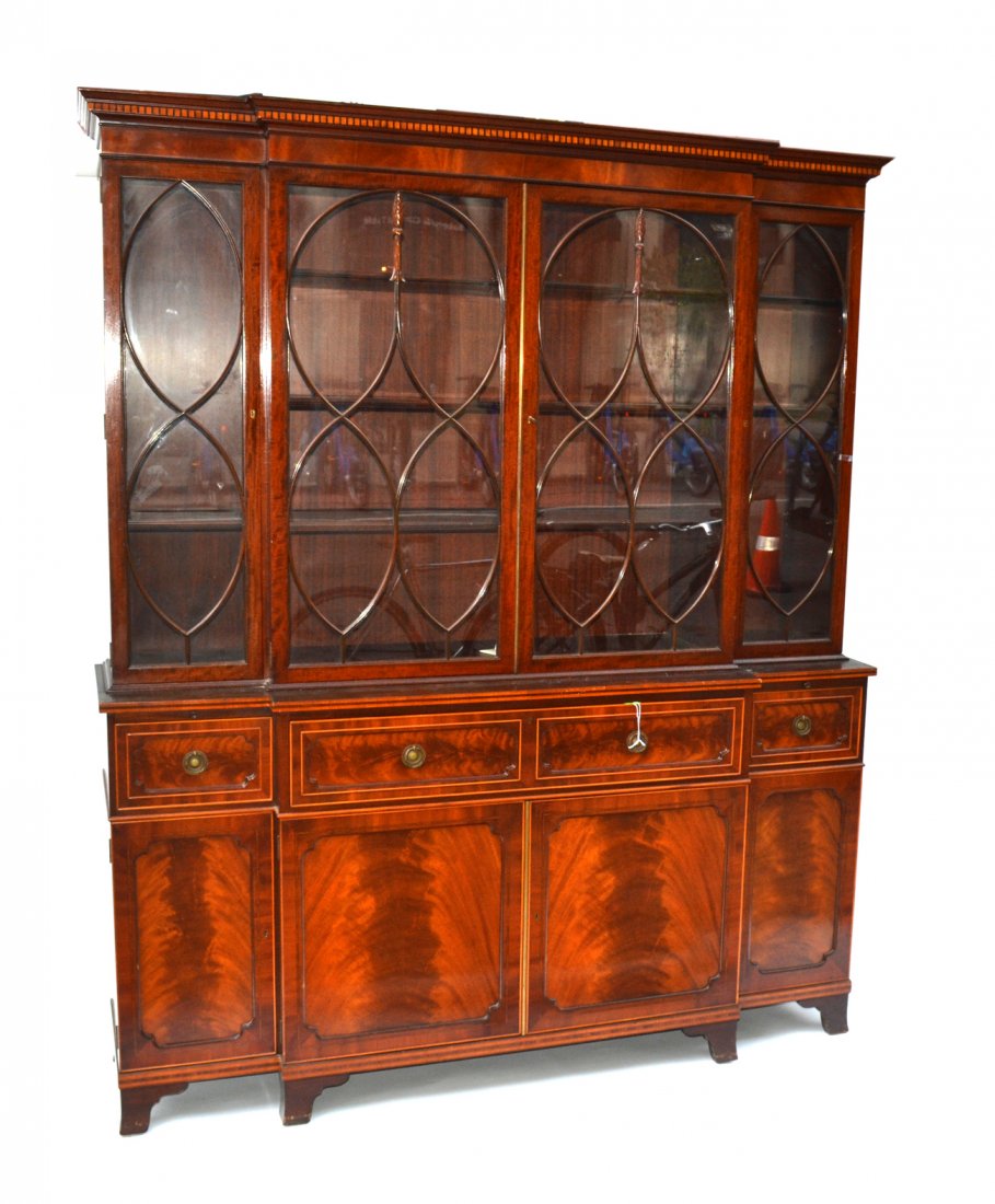 Schmieg and Kotzman Breakfront: Mahogany Hepplewhite style breakfront having four glazed doors over a base cabinet with three drawers and four doors, raise on bracket legs. Signed. [82" H X 68" W x 19" D].