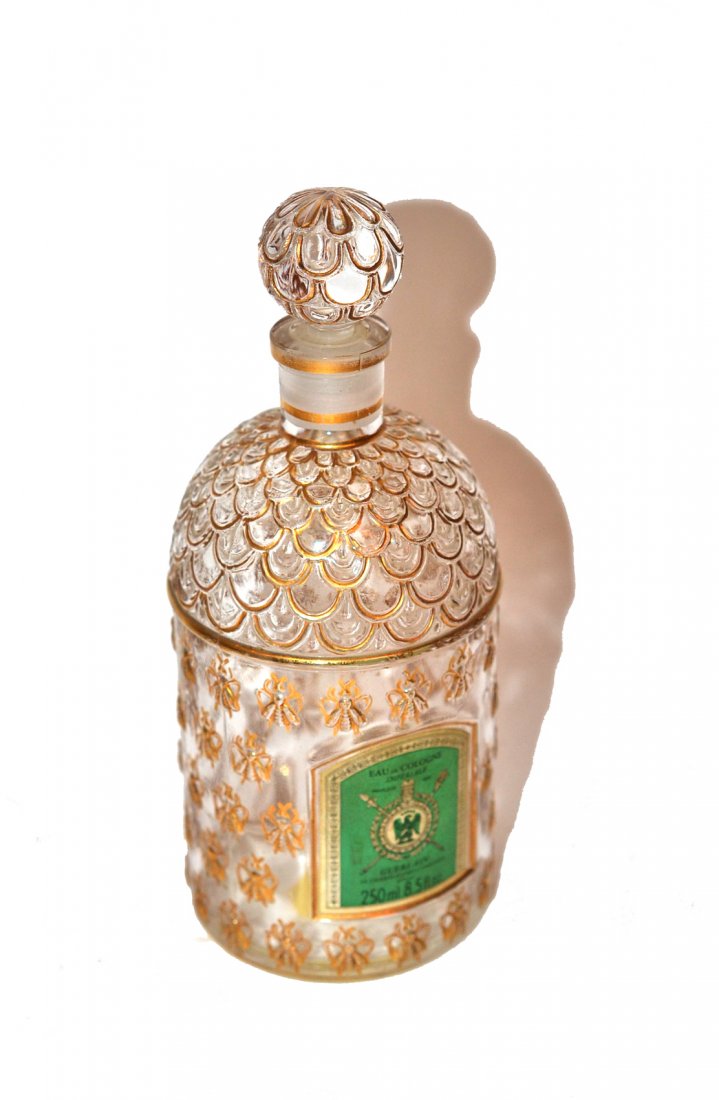 Guerlain Perfume Bottles: Crystal bottle with gold fleur de lis design. [6.5" h].