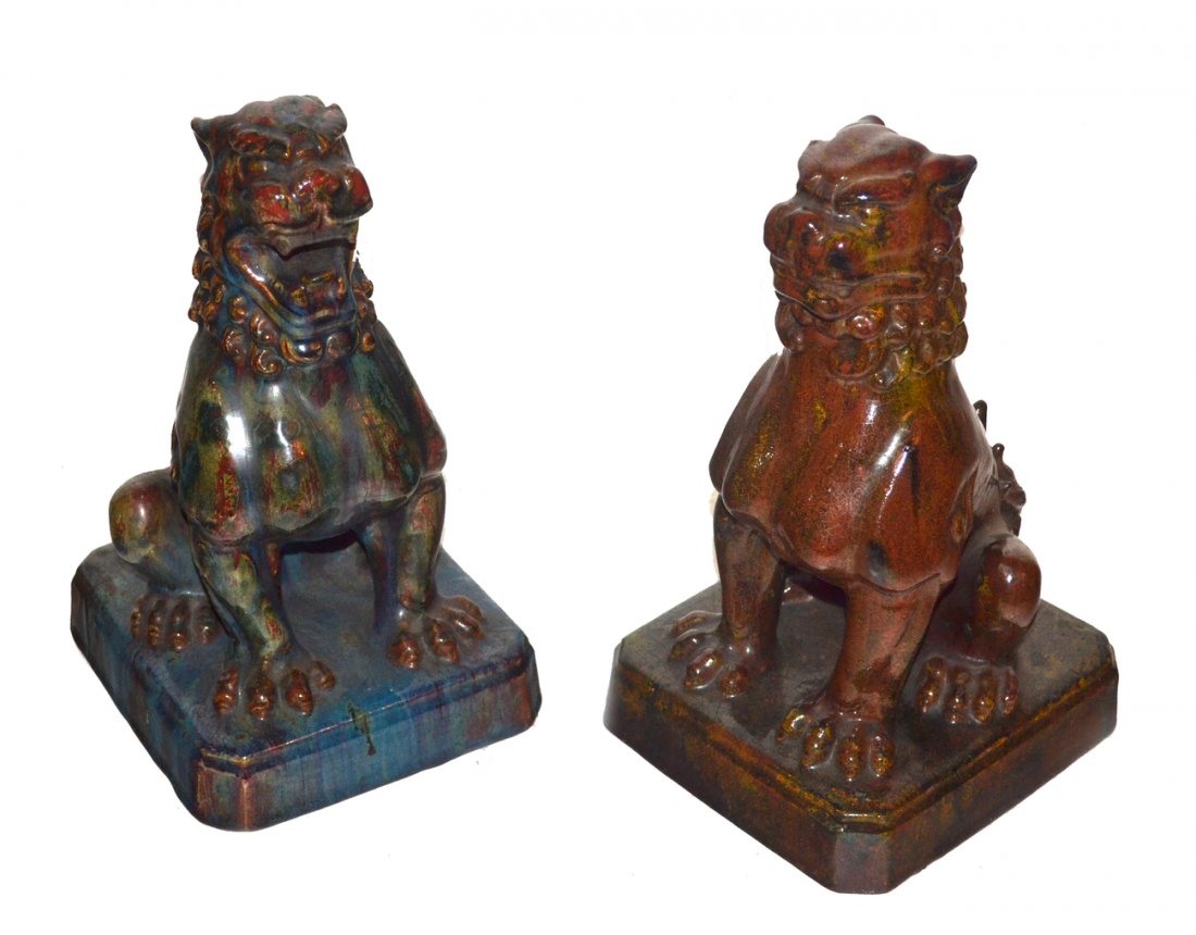 Pair of Asian Ceramic Foo Dogs: Both feature mottled drip glazes, one predominantly red, the other blue. 6 1/2" w x 7 1/4" d x 11 1/2" h. Both weighted.