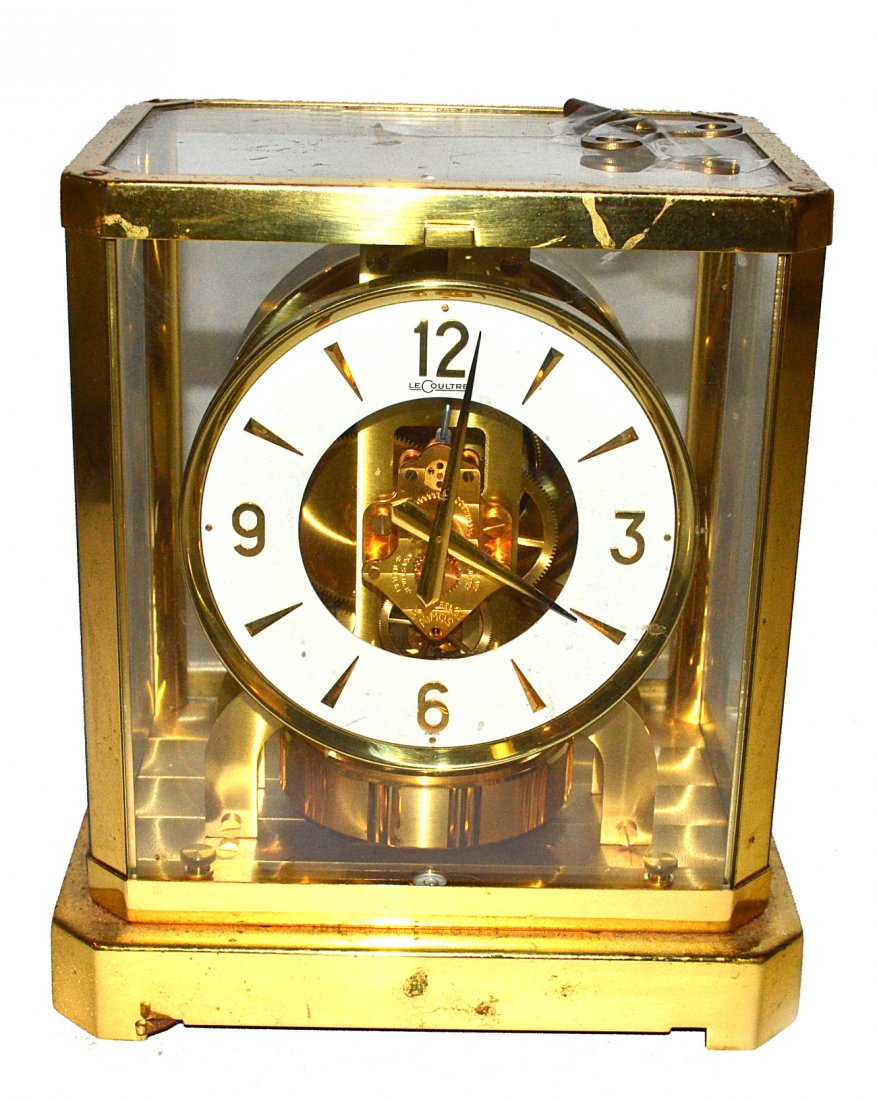 LeCoultre Atmos Clock: Brass and glass cased atmos clock with enamel dial. [9 1/4" x 8 1/2" W x 6 1/2" D].