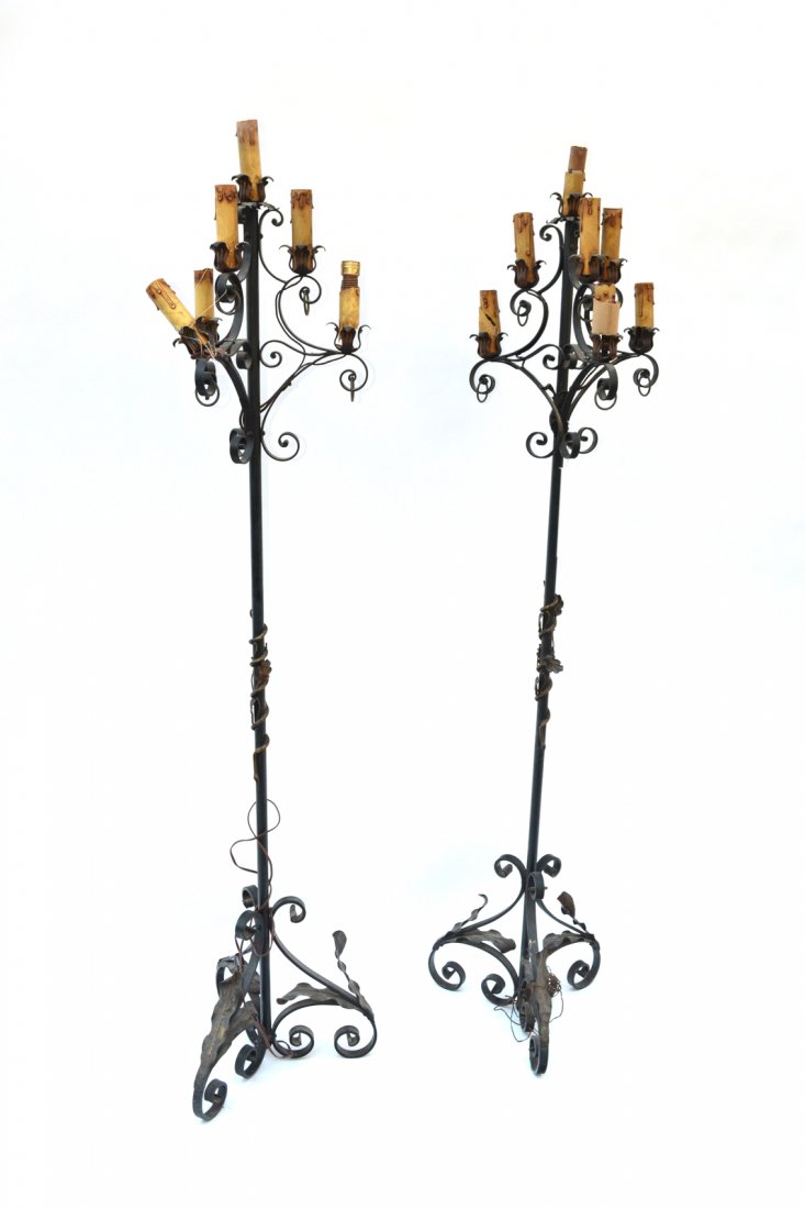 Pair of Gothic Floor Lamps: Pair of iron floor lamps, six candleholders with tripod bases. [67" H x 13" D x 15 1/2" D to base]. Good condition.