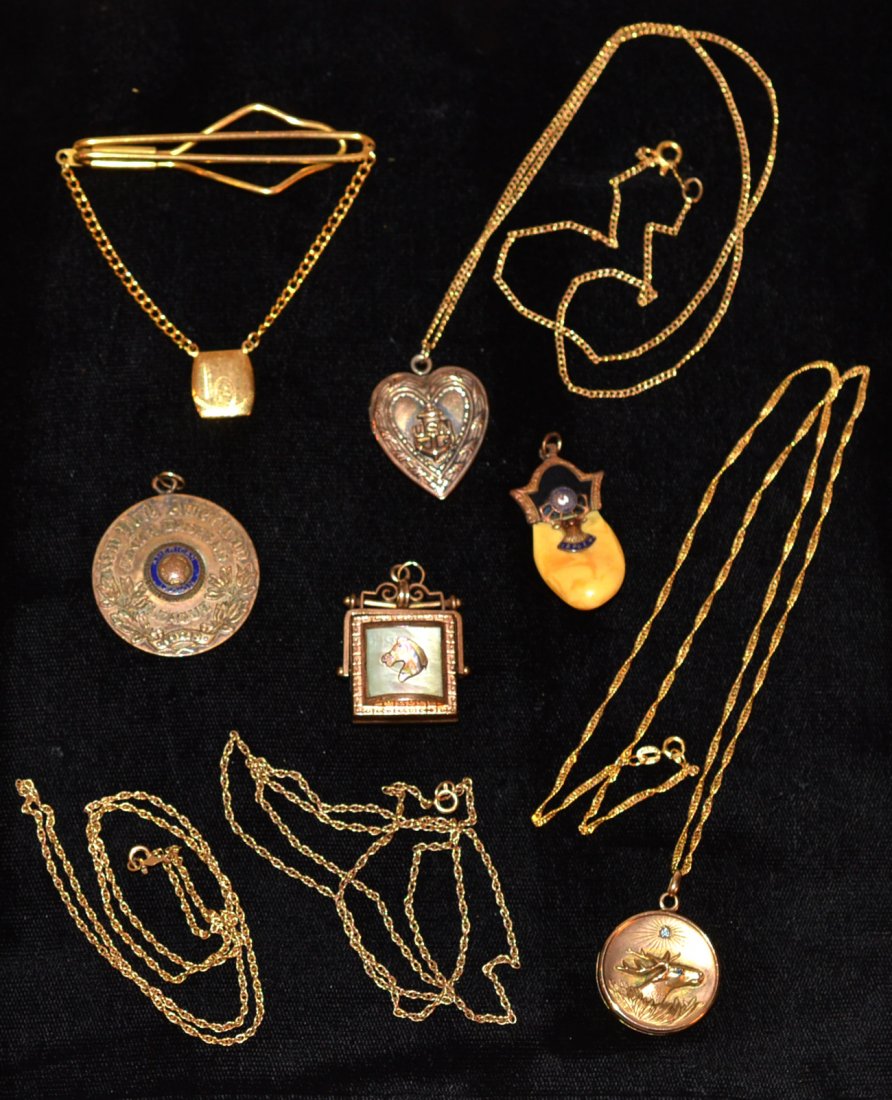 Assorted Costume Jewelry: Three lockets, tie bar, two chains and two pendants.