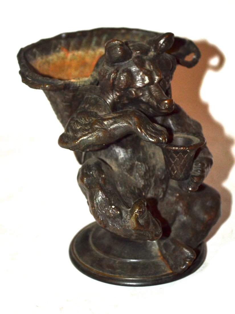 Bronze Figure of a Bear: The seated bear having basket woven backpack and honey pot. Good condition. [6" high].
