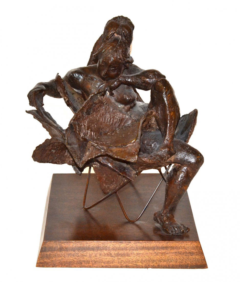 Bruno Lucchesi, Bronze Sculpture: Study of a nude woman reading a newspaper. Mounted on a mahogany base.