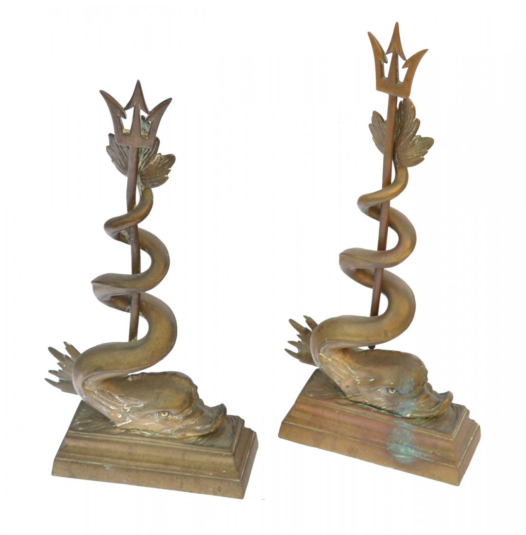 Pair of Brass Dolphin-Form Andirons: Each pierced with a trident. [21" h].