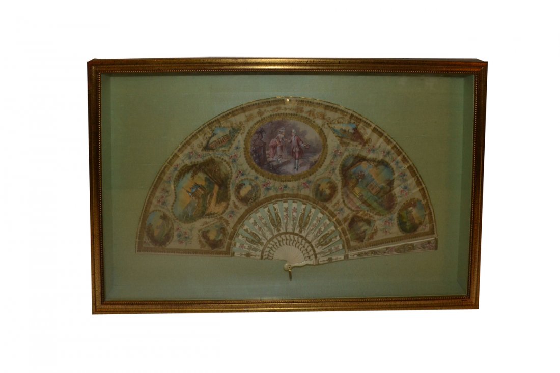 Painted Silk Fan in Shadow Box: Decorated with scenes of courtiers and landscapes. Having painted ivory staves. In good condition. Frame [25" w x 15 1/4" h x 1 3/4" d].