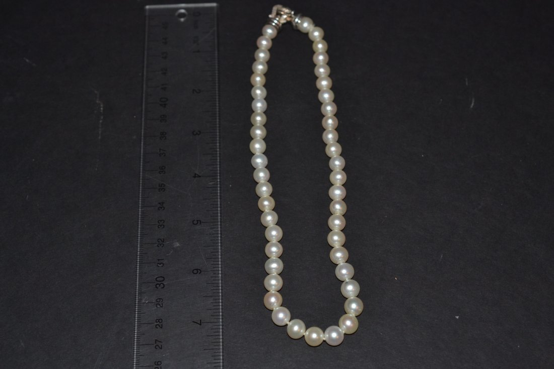 David Yurman Pearl, Sterling and Diamond Necklace: Single strand necklace comprised of 46 8mm dia. freshwater pearls, features sterling clasp with diamond accent stones and stamped "D. Yurman". [16 1/8" long end-to-end].