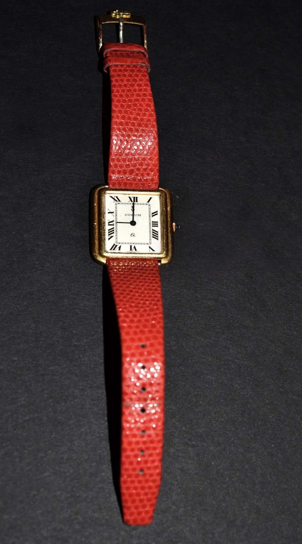 Corum 18k Gold Wrist Watch: 18k case with red leather strap and gold filled buckle. Not tested, sold "as is".