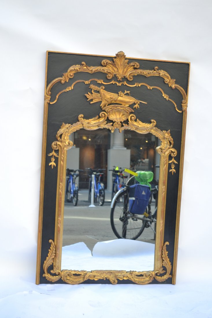 French Trumeau-Style Mirror: With ebony frame, ornate gilt wood shell, scroll and leaf decor.