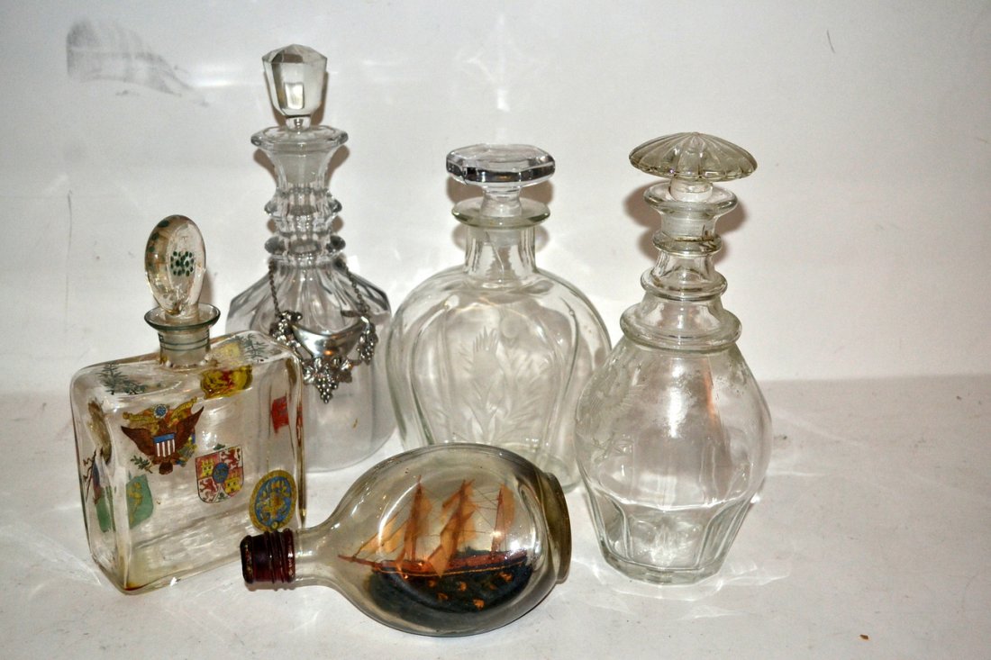Four Glass Decanters and Other: Four decanters with stoppers, and a ship in a bottle.