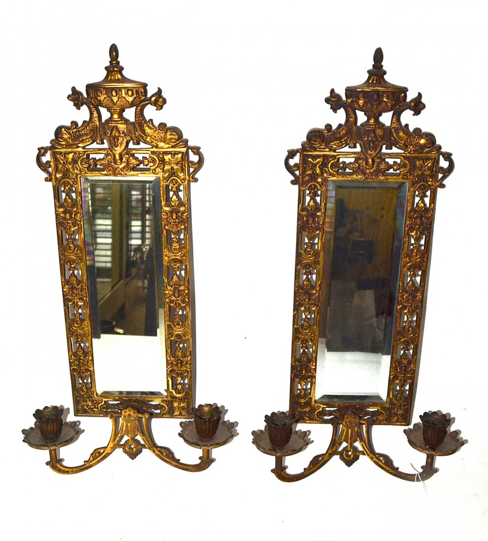 Pair of Mirror Back Sconces: Pair of Bradley & Hubbard two-arm sconces with a dolphin-form crest and reticulated design. [21 1/2" H x 11 1/2" W]. Good condition.