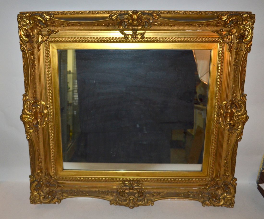 Antique Rococo Revival Gilt Wood Mirror: Features acanthus leaf, opposing "c"-scroll, and scaled elements throughout. [34 1/2" x 38"]. Some chips with minor losses.