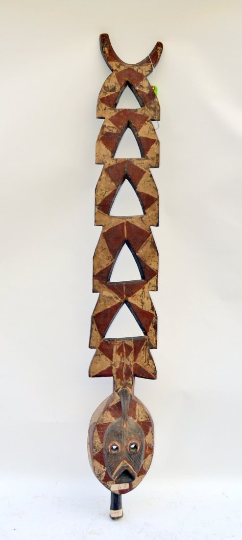 Elaborate African Ceremonial Mask: Carved and polychromed wood mask headdress with geometric element throughout. [10" w x 6 1/2" d x 70 1/4"]. Multiple defects, sold "as is".