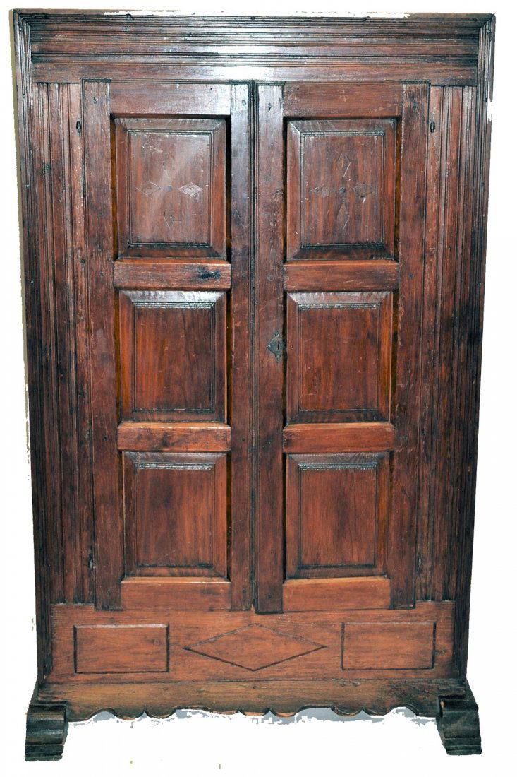 Antique European Two-Door Cabinet: Assembled cabinet with each door featuring floating panel construction, sides bearing carved lozenge design with rosette accents, and corbel feet. [38 1/2" w x 15 7/8" d x 62 3/4" h]. From the Estate