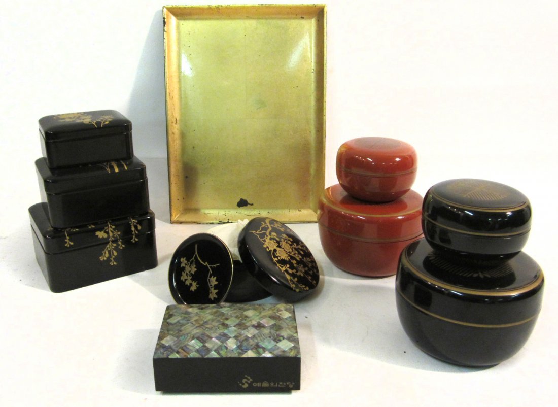 Group of Asian Lacquered Boxes: Nine boxes comprising circular and rectangular examples variously decorated with gold painted floral and geometric designs. Includes a playing card box with abalone inlay. Sizes from 3 3/8" dia x 2 1/