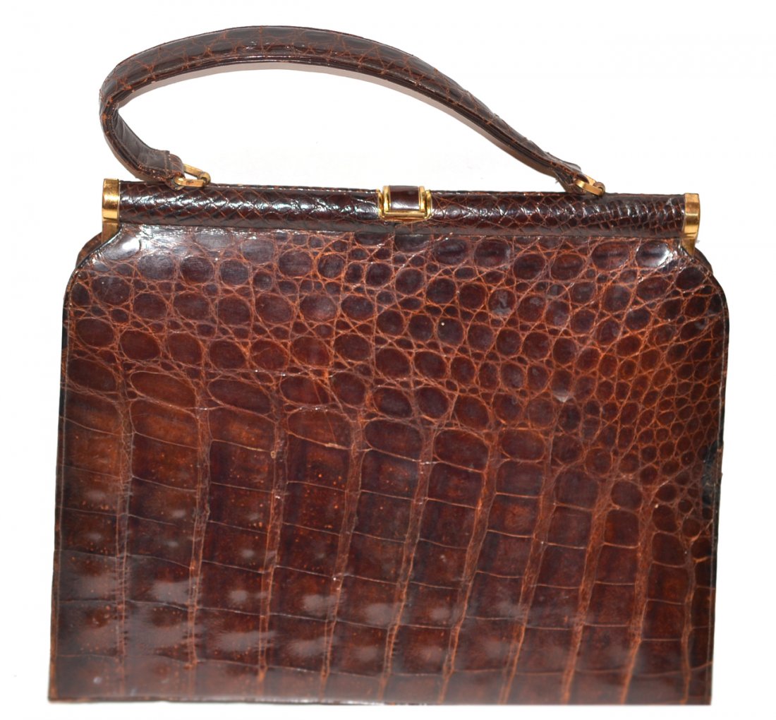 Large Brown Crocodile Handbag: Clasp frame closure leather lined with one zippered and two open pockets. Some light surface scratches and wear to handle. Overall good condition. [13 5/8" w x 16" h x 4 1/8" d].