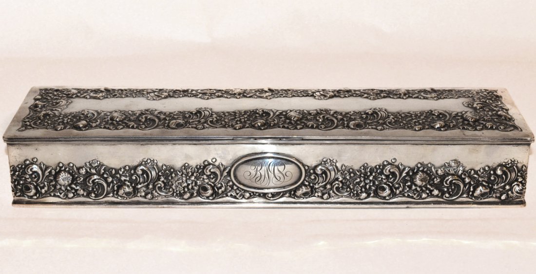 Gorham Sterling Jewelry Box: The long rectangular form with repousse floral bands and monogrammed medallion. Velvet lined. In good condition. [15 5/8" l x 4 1/8" d x 2 3/8" h]