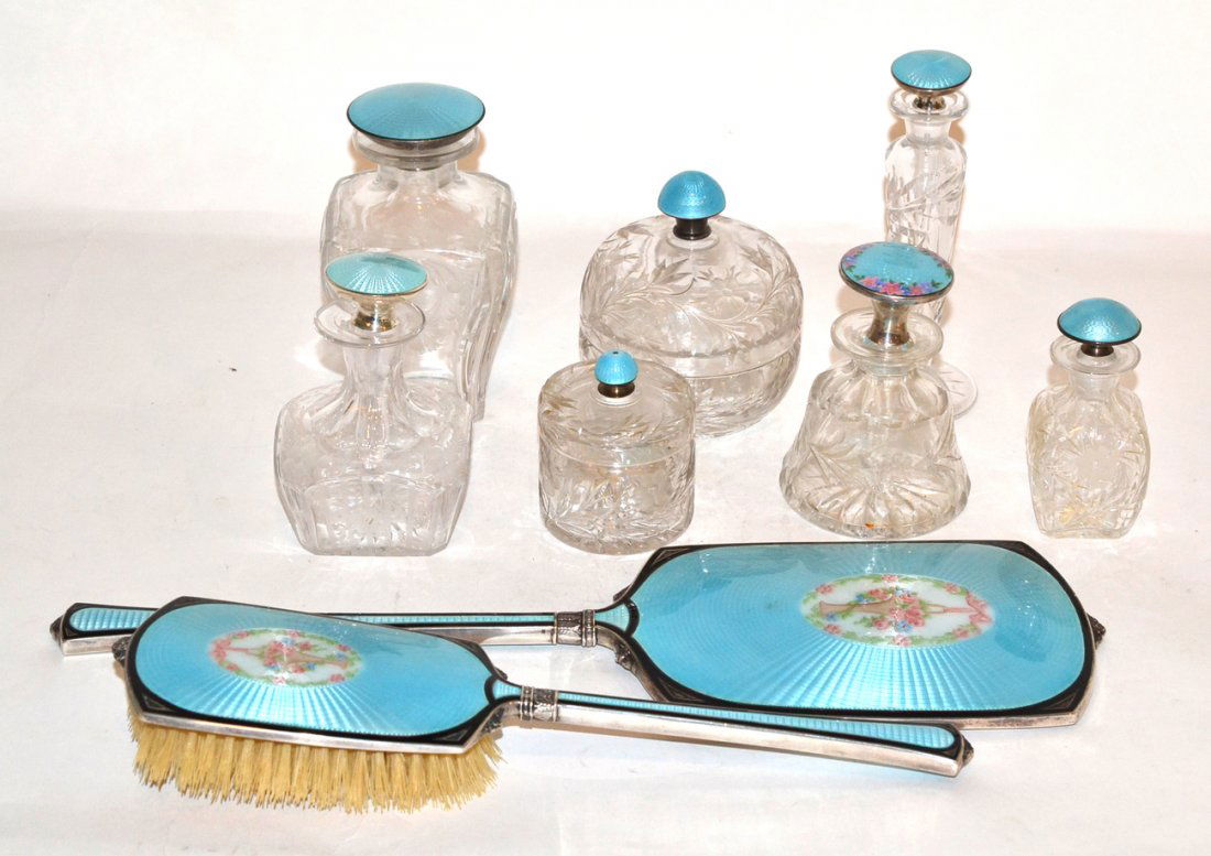 9pc. Assembled Silver Enamel Dresser Set: Comprises two hand mirrors, five assorted scent and lotion bottles and two jars. All with engine fumed pale blue enamel. Some with floral decoration. All in good condition. [15 1/2" largest]