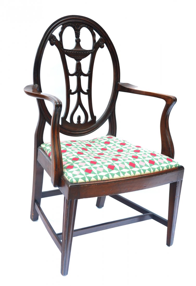 Hepplewhite Style Open Armchair: Having oval back with carved center splat and slip seat. Raised on tapered legs. Wear commensurate with age. [39 1/2" h x 24 1/4" w x 19" d]