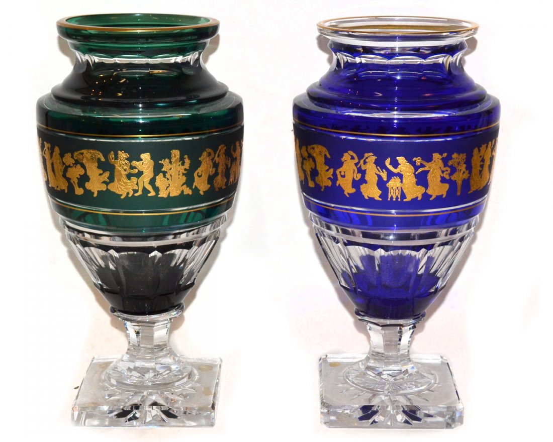 Two Cased and Cut Crystal Urn-Form Vases: Vases in the manner of Val Saint Lambert, comprising of one cased in green and the other in cobalt blue. Both feature gilt accents, band at center with classical style figures, and square base. Both s