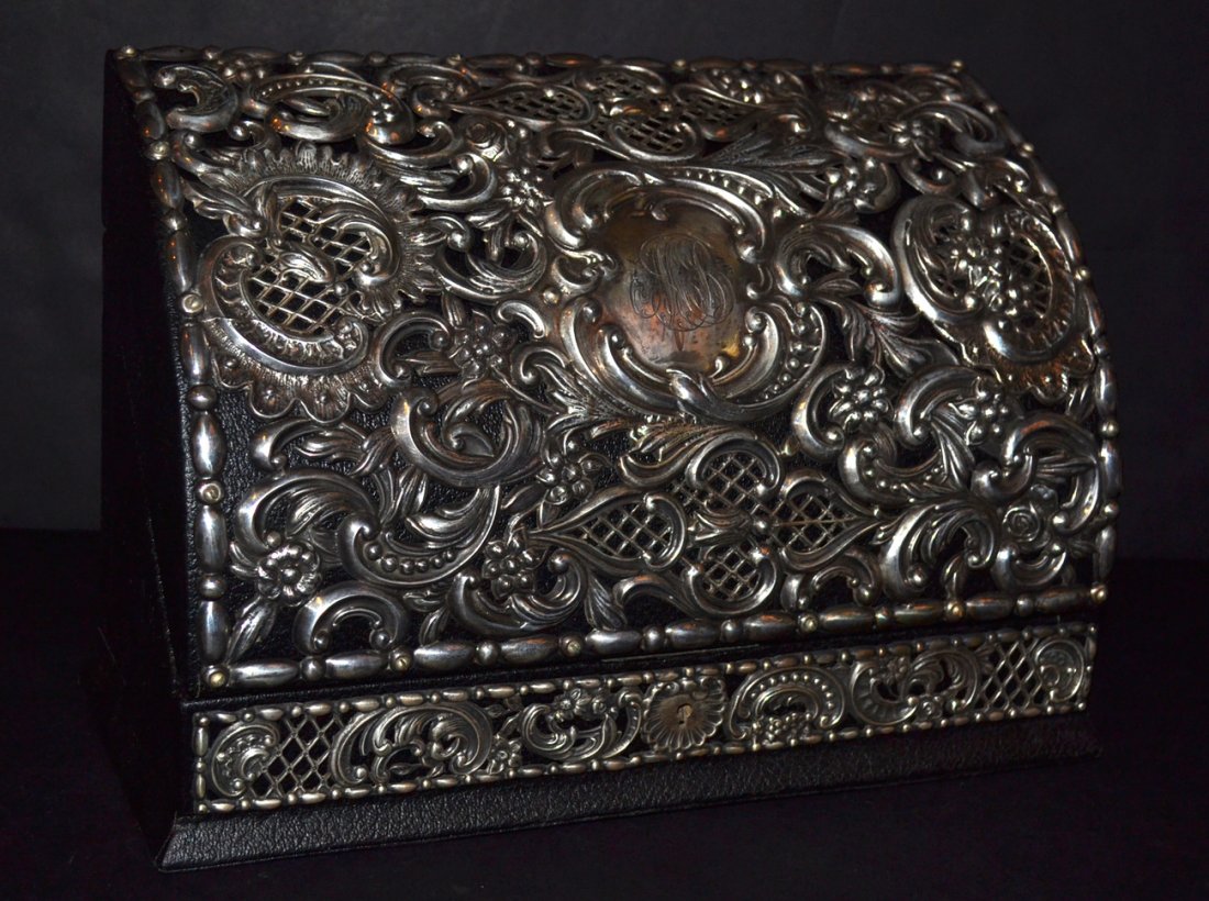 Sterling and Leather Letter Box: Repousse scroll and floral decoration on black leather domed box. Good condition. [11 1/2" w x 5 1/4" L x 8" h]