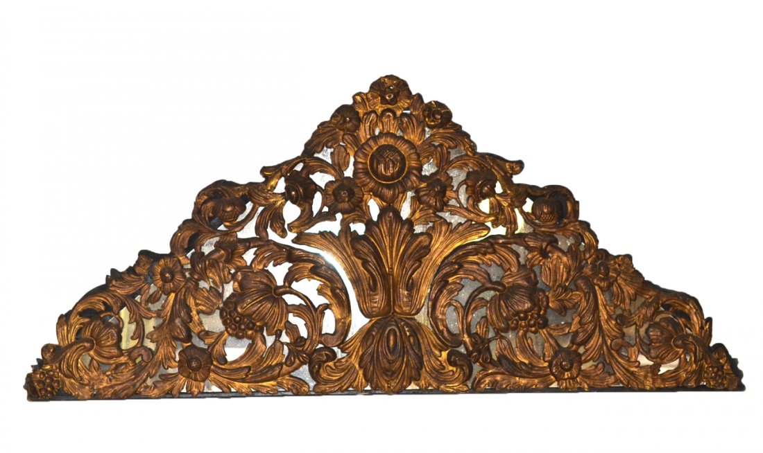 Vintage Gilt Tole and Mirrored Pediment: Ornate pierced tin triangular pediment featuring a scollilng leafy and floral elements against a mirrored background. [41" w x 1 1/2" d x 18 1/2" h]. Cracks, minor losses and dents.