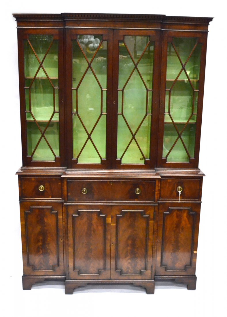 Georgian-Style Breakfront: Two-section mullion glass mahogany banded breakfront. [50" L x 17 1/2" D x 75" H]. Veneer missing on lower right door, chip in left cornice, two escutcheons missing.