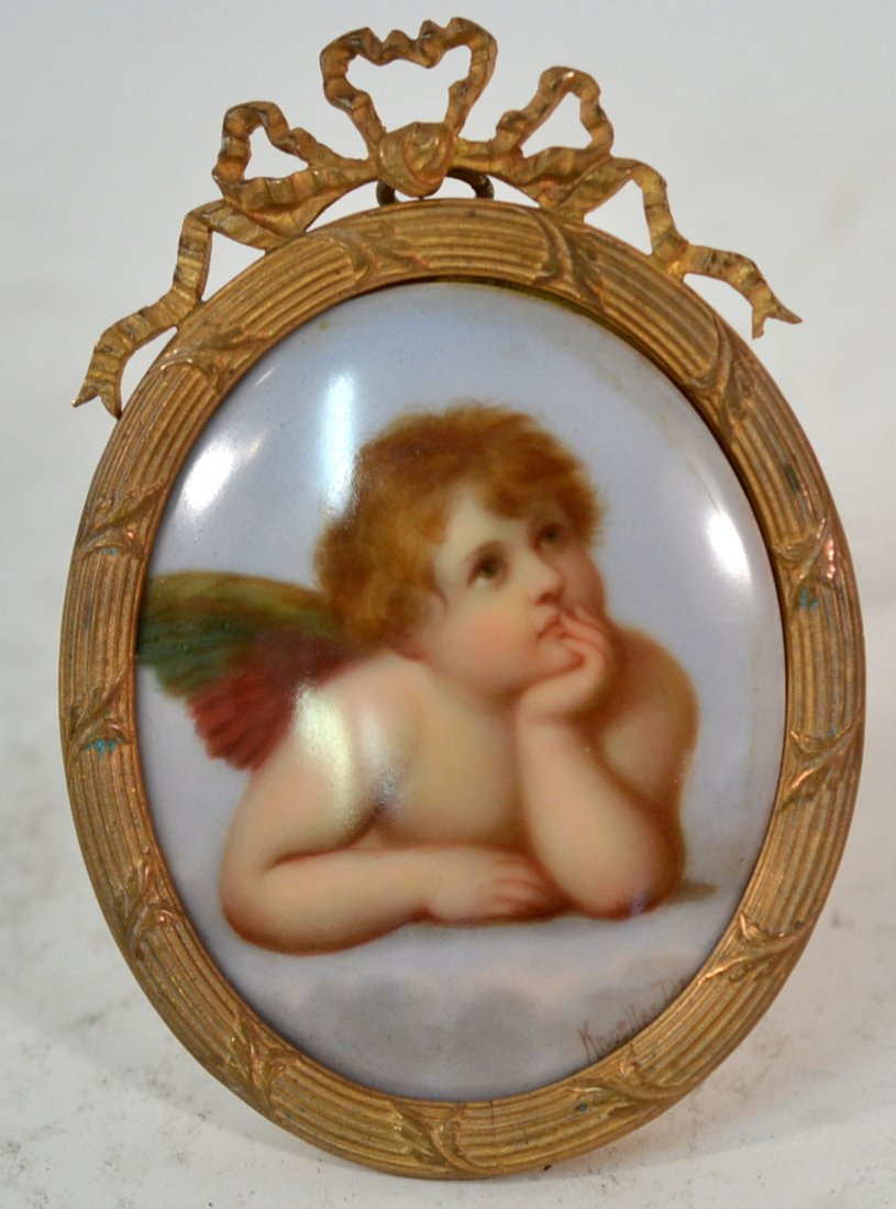 Bronze Framed Porcelain Plaque of an Angel: After Raphael. [3 1/4" W x 4 1/2" H]. In good condition.