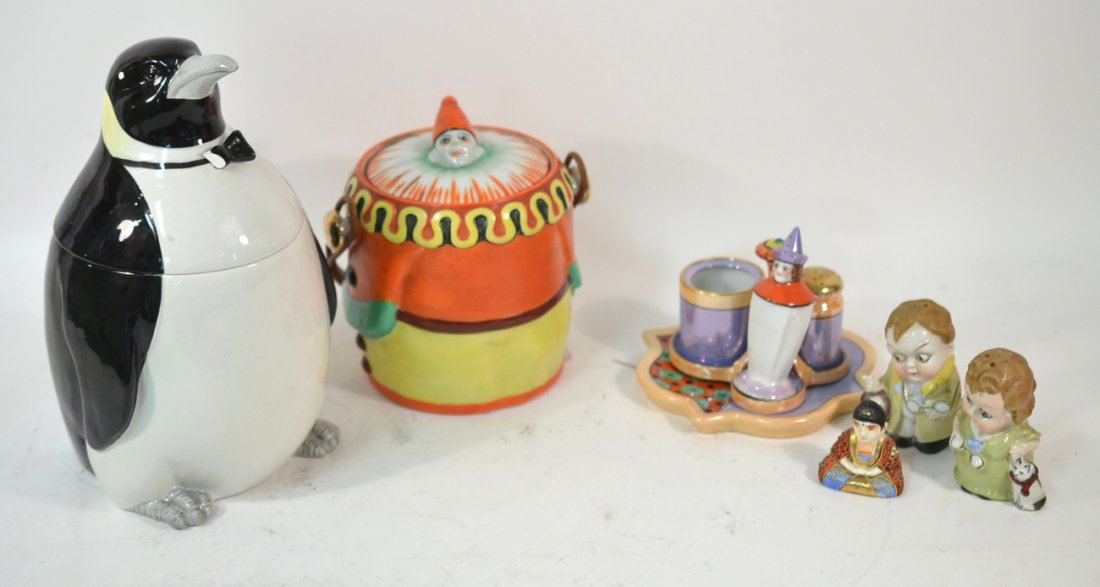 Seven Figural Japanese Porcelain Serving Articles: Vintage porcelain comprising: pair of bespeckled children-form shakers (3 1/2" H), clown-form cookie jar with wicker handle (7"H), poppy-form condiment stand missing one shaker (3 3/4"), trivet with p