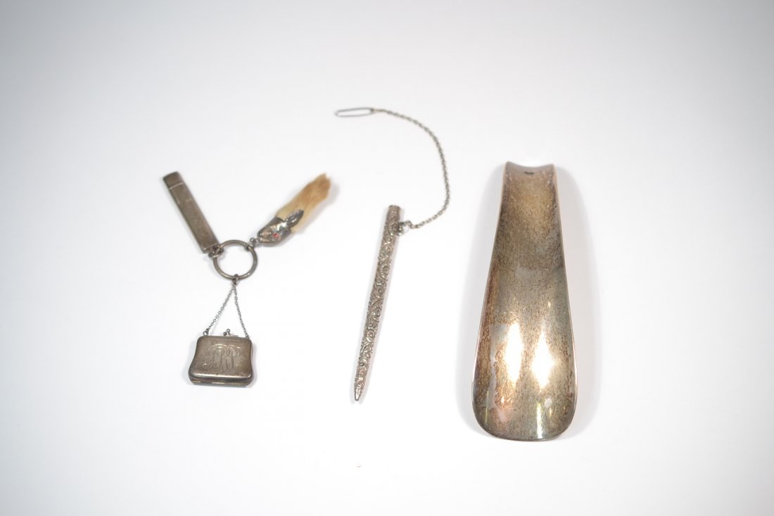 Group of Five Silver Articles: Comprises sterling shoehorn, sterling cased pencil, needle case, rabbit foot and miniature purse.