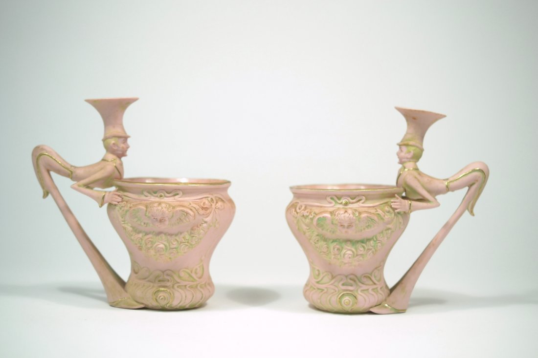 Schafer & Vater 'Alice in Wonderland' Sugar Bowls: Pair of pink bisque porcelain figural sugar bowls. Both stamped on bottom "3850". [Each 5 1/2" W x 3 3/4" D x 5 1/8" H]. Soiling and stains, otherwise complete.