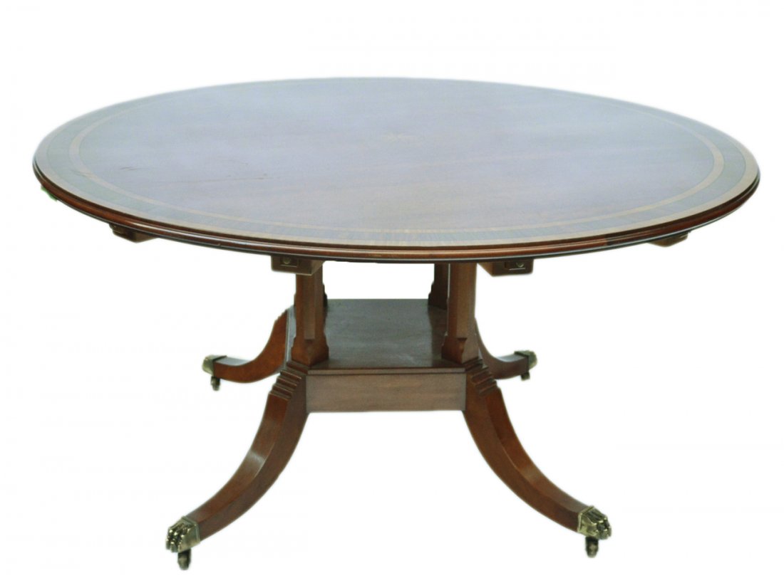 Sheraton Style Dining Table: Circular mahogany double banded single pedestal dining table with six leaves. The leaves are stained to match but the grain is not continuous. [60" Dia x 30 1/2" H]. The table is complete and the leav