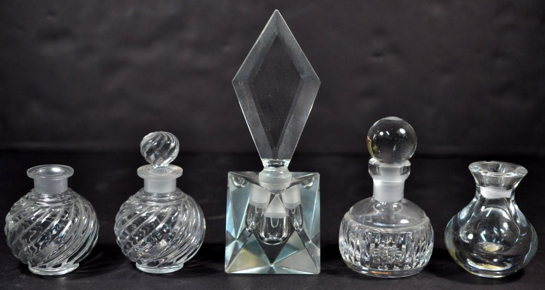 Five Glass Scent Bottles: Includes pair of Baccarat swirled glass bottles. [H of tallest: 7 1/2"]. One lacking stopper, Orrefors bottle with chipped rim, otherwise good condition.