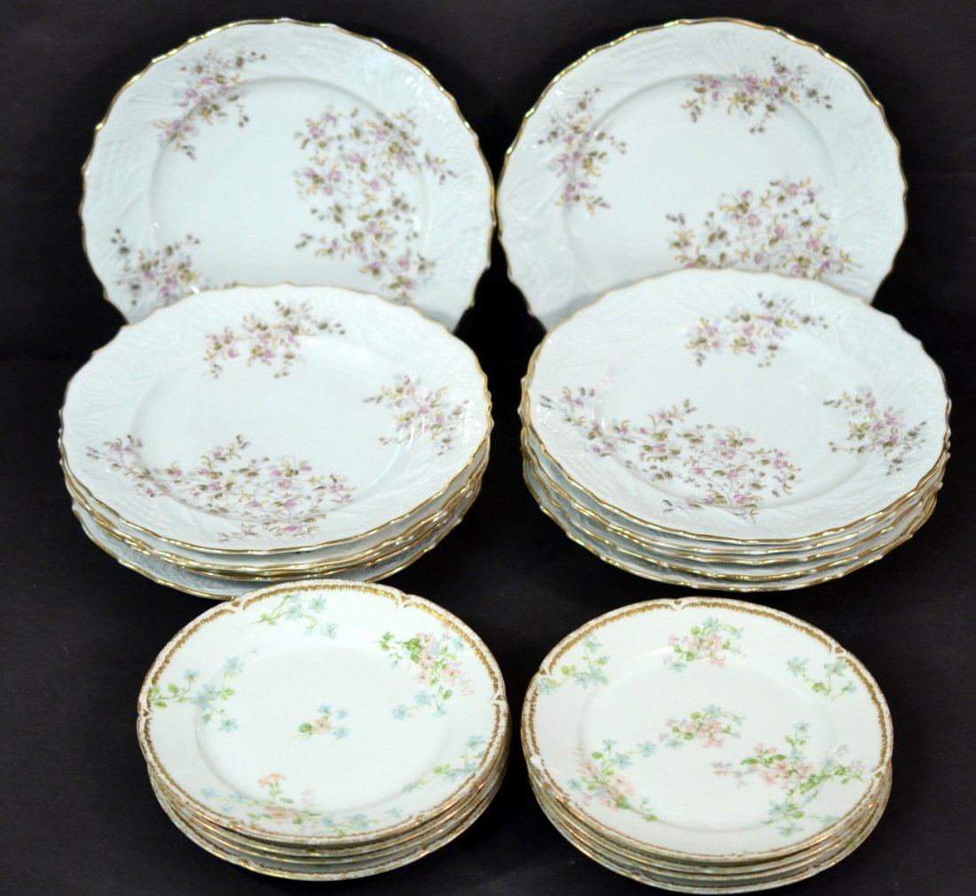 Twenty Assorted Dinnerware Items: Comprises set of 12 Austrian porcelain soup bowls along with a set of 8 Limoges floral decorated plates. Wear to gilding along with some flaking and chips.