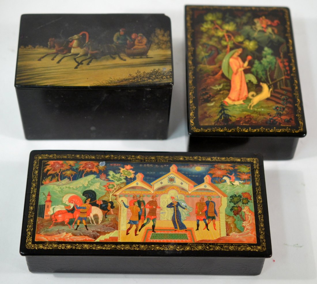 Three Russian Lacquer Boxes: Each with decorated hinged cover. [7 3/4" x 3 3/4" x 1 1/2" largest]. Light scratches and scuffs.