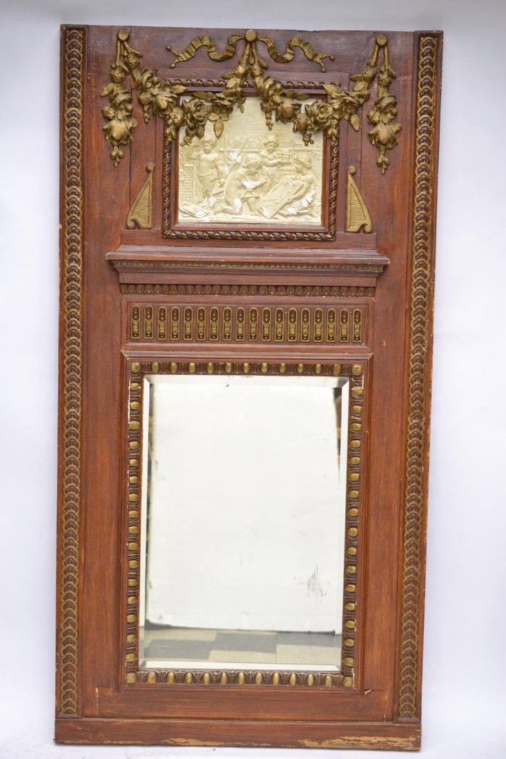 English Style Trumeau Mirror: English-style trumeau mirror with elaborate pediment bearing a high-relief plaster plaque with parcel gilt and carved floral swags. [Overall 34" x 65 1/2"]. Plaque bears chipping, paint losses, scratc
