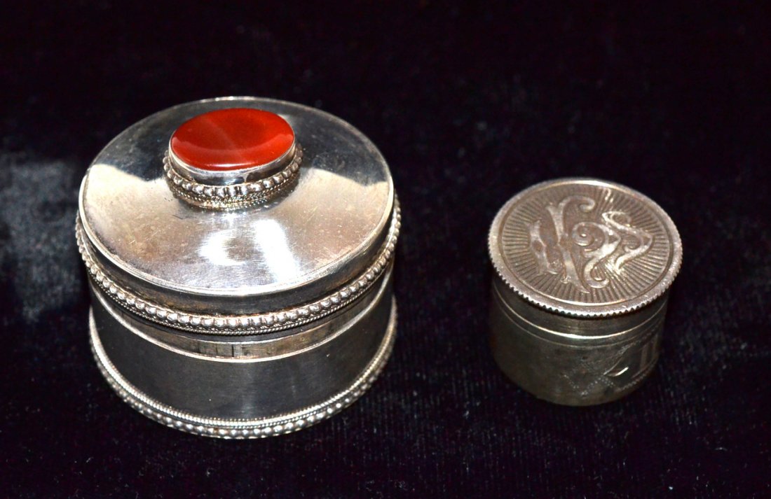 Two Silver Trinket Boxes: The larger mounted with carnelian cabochon and with an interior scene; the smaller with a monogram. [Larger: 1 3/4" Dia]. Both in good condition.