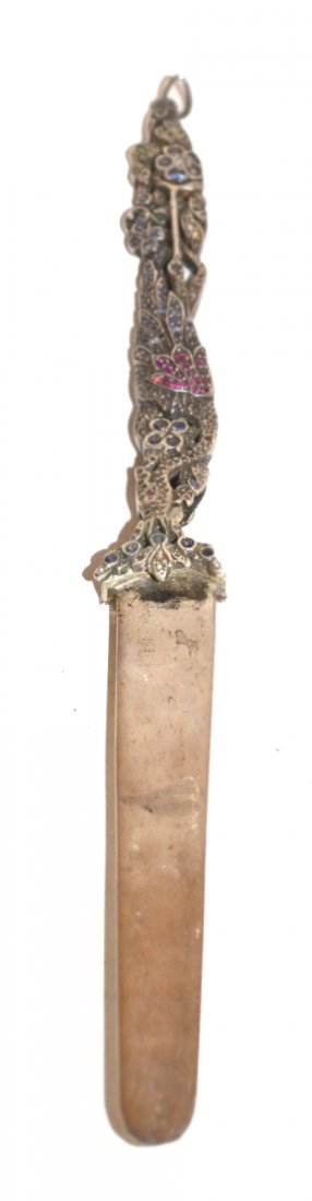 Jeweled Silver Letter Opener: The handle in the form of an exotic bird amidst flowers. One side chased, the other mounted with sapphires and rubies. The blade is marked sterling. [8 1/2" L]. No visible repairs or restorations. App