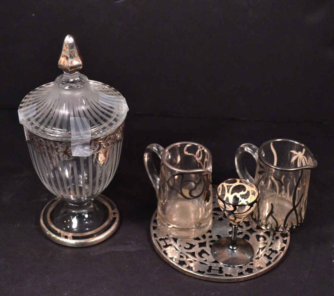 Six Silver Deposit and Overlay Glass Articles: Comprises covered jar, two creamers, trivet, salt shaker and black glass vase. [9" tallest]. All in good condition.