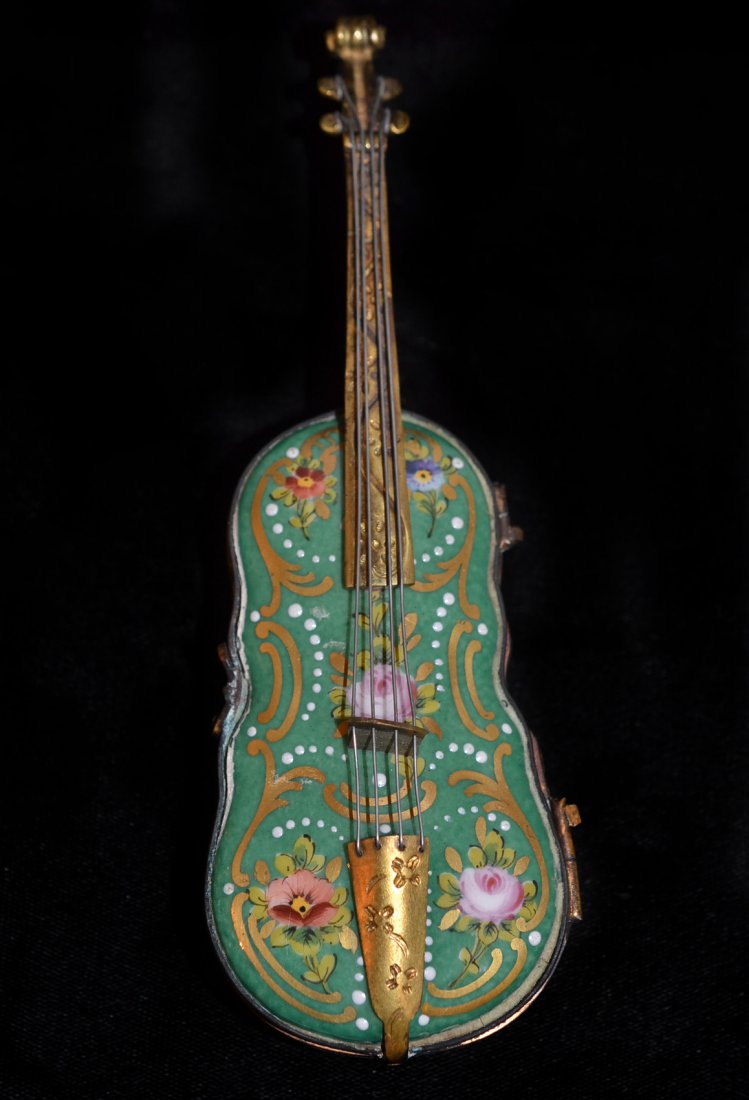 Enameled Porcelain Violin-Form Box: French gilt metal mounted porcelain trinket box with gilt and enameled decoration and hinged cover. [6 1/2" l]. Good condition.