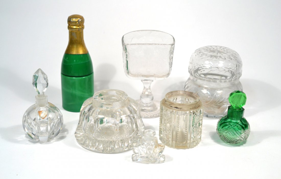 Group of Eight Assorted Table Articles: Includes scent bottles, jars, champagne bottle form container, etc. Two jars lacking covers and with chipped rims.
