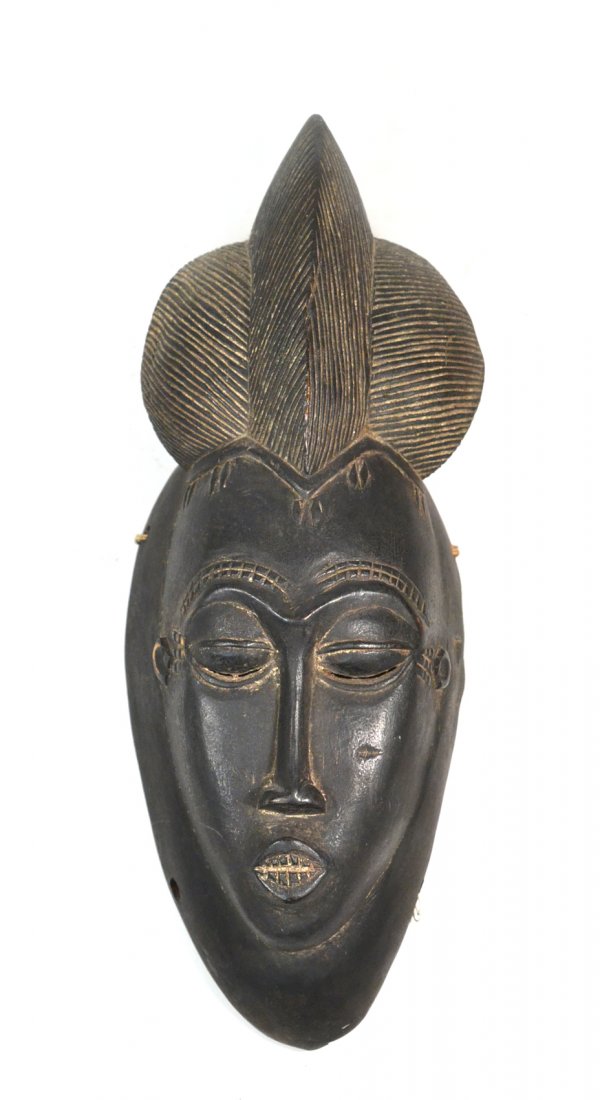 African Mask: Carved and ebonized wood. Wear commensurate with age. [15" H].